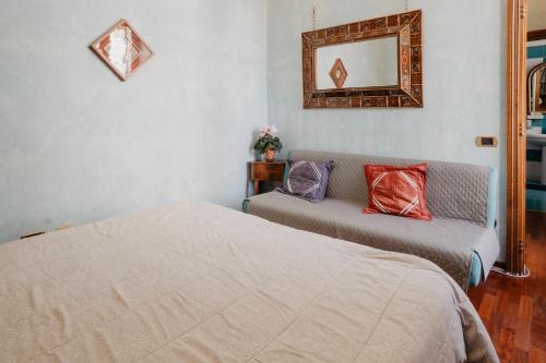 a bedroom with two beds and a mirror on the wall at Villa Luigi XVI in Taranto