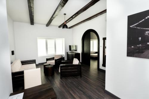 a living room with black and white furniture and a painting at Casa Bolta Rece in Sighetu Marmaţiei