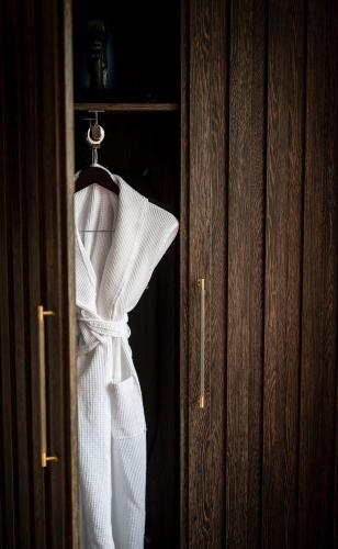 a white dress is hanging on a door at Duisdale House Hotel in Isleornsay