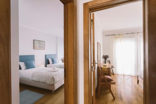 a bedroom with a bed and a room with a mirror at Best Houses 84 - Mar Salgado in Ferrel