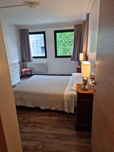 a bedroom with a bed and a table with a lamp at Victoria Royal Garden in Como