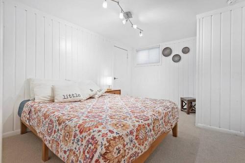 a bedroom with a bed in a white room at Mid-century, modern oasis, fully stocked in Murray