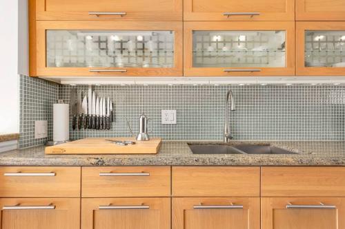 a kitchen with wooden cabinets and a sink at Mid-century, modern oasis, fully stocked in Murray