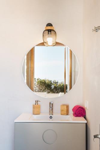 a bathroom with a sink and a mirror at Sa Punta Dúplex Cala Ratjada in Cala Ratjada