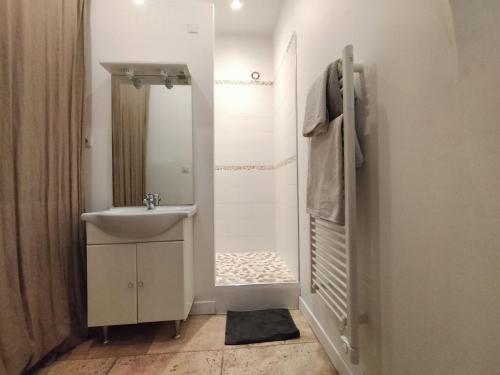 a white bathroom with a sink and a mirror at CORDELIERS MAIRIE in Aix-en-Provence