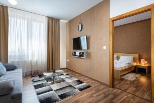 a bedroom with a mirror and a bed and a tv at TATRYSTAY Oliver Apartments in Štrbské Pleso