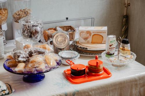 a table with a plate of food and other items on it at Villa Luigi XVI in Taranto