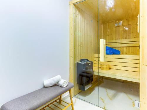 a sauna with a bench and a glass wall at Irini Luxury Rooms in Split