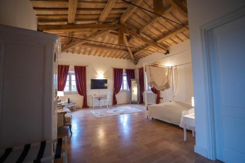 a large room with a bed and a television at Villa Nena in Tolentino