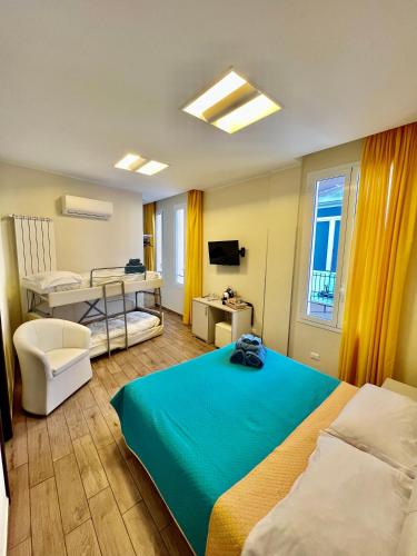 a hotel room with a bed and a desk and a bed at Casa Zeffirino in Sanremo