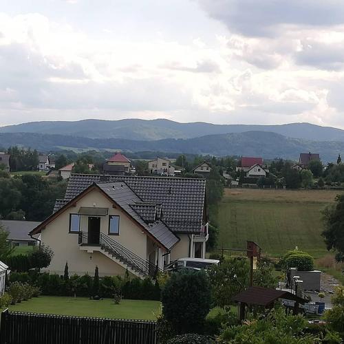 a house with a view of a field and mountains at WillaTwins in Tomice