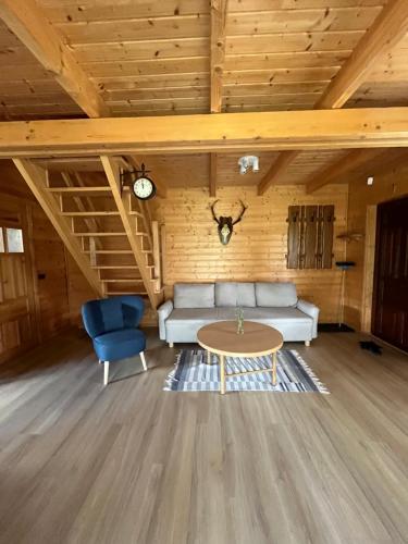 a living room with a couch and a table at Punkt Mazury in Sędki