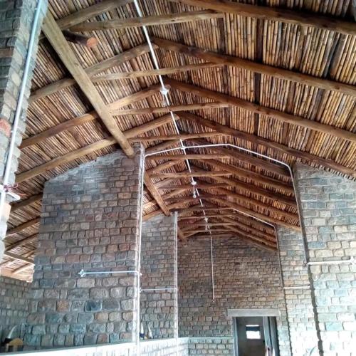a room with a brick wall and a wooden ceiling at Katurum Kidepo lodge in Loitanit