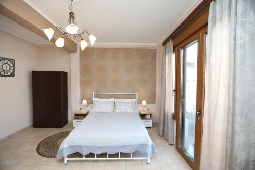 1 dormitorio con cama y ventana grande en Niki's apartement en Kavala