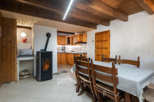 a kitchen with a table and a wood stove at TATRYSTAY Chalet Kristina in Belá