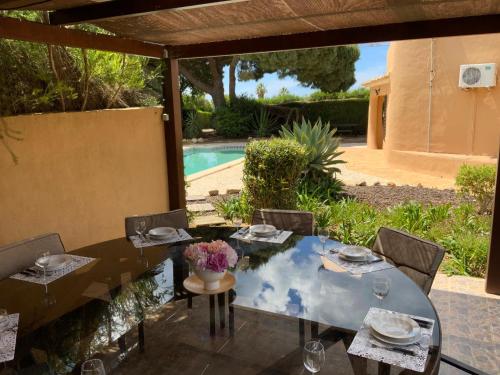 a dining table and chairs with a view of a pool at Casa Canavial in Lagos