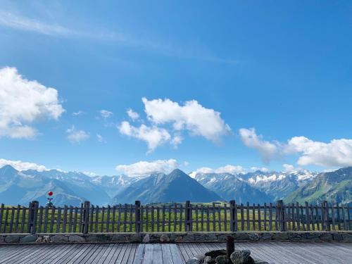 a wooden fence with a view of mountains at Schneekarhütte in Mayrhofen