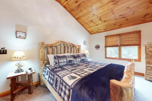 a bedroom with a bed and a wooden ceiling at Our Mountain Blessing - STR License #026,912 in Mashburn Mill