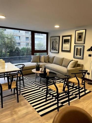 a living room with a couch and a table at AT HOME El Golf in Santiago