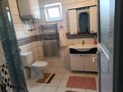 a small bathroom with a toilet and a sink at Kadı Home 