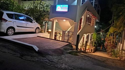 a white van parked in front of a house at night at The Lotus Home in Port Blair