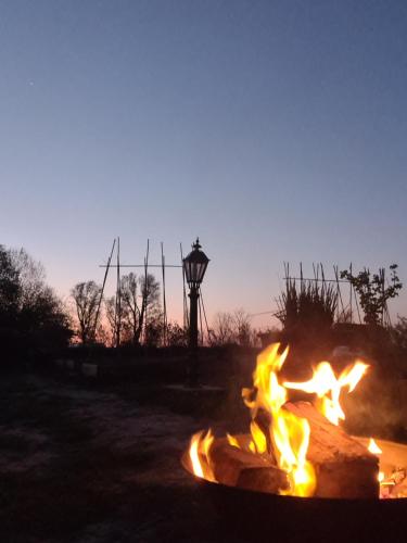 a fire pit in a field at sunset at De luxe overkapping in Middelburg