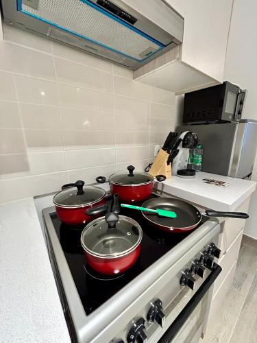 two pots and pans on a stove in a kitchen at The Hive Retreats in Yas Island in Abu Dhabi