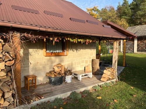 a house with a wooden deck and a building at Siedlisko pod Lasem in Józefów