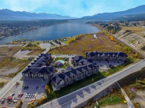 an aerial view of a large building next to a river at Mountain getaway condo - 5 min walk to the beach! in Invermere