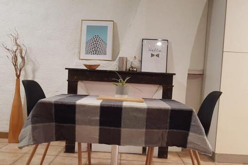 a dining room table with a black and grey table cloth at Studio Orléans Châtelet in Orléans
