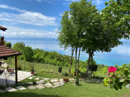 a garden with a view of the water at Paradise Nest in Ohrid