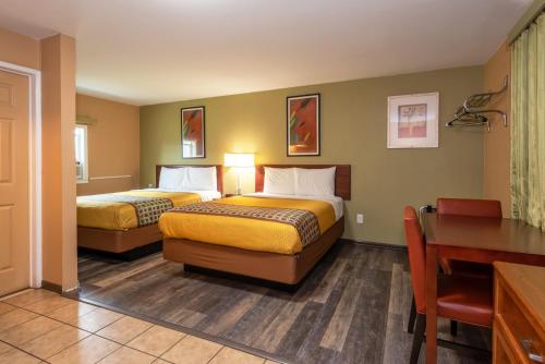 a hotel room with two beds and a desk at Town Motel in Forks