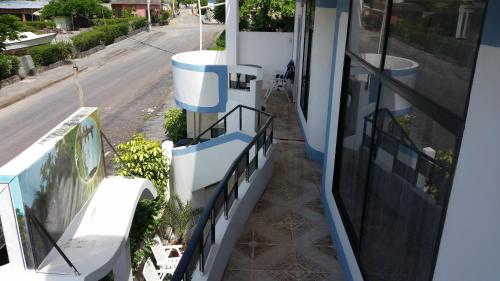 a balcony of a house with a view of a street at Hostal Cerro Azul in Puerto Villamil