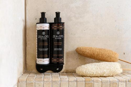 two bottles of oil and a brush on a wall at Nikoleta Hotel and Villas in Limenas