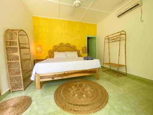 a bedroom with a bed and a large rug at Banana Surf House in Arugam Bay