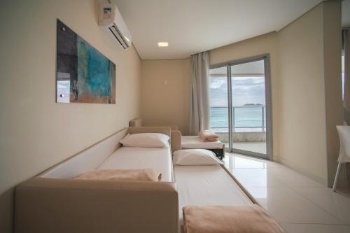 a hospital room with two beds and a view of the ocean at Slaviero Ingleses Convention in Florianópolis