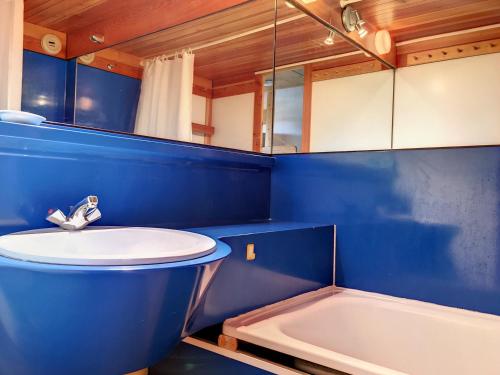 a blue bathroom with a sink and a bath tub at Studio Les Arcs 1800, 2 pièces, 5 personnes - FR-1-346-426 in Arc 1800