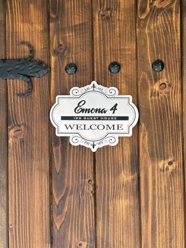 a wooden fence with a sign on it at IRB Guest House Emona 4 in Nesebar