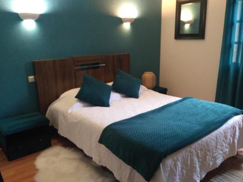 Un dormitorio con una cama con una manta azul. en Bienvenue !, en Moissac