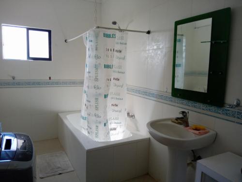 a bathroom with a sink and a shower curtain at the million view room habitacion en resort solo adultos in La Laguna