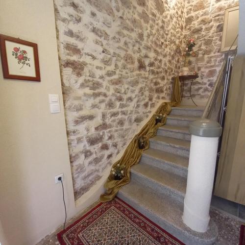a staircase in a building with a stone wall at Casa da Sogno Elegant Studio in Nafpaktos