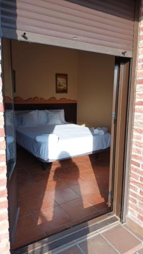 a bedroom with a bed inside of a building at Hotel Restaurante Comendador Añon de Moncayo in Añón