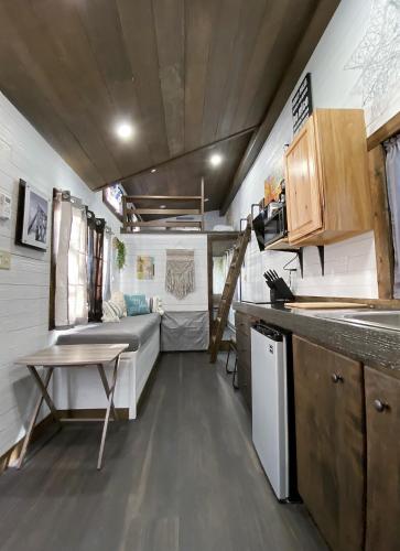 a kitchen with a couch and a table in a trailer at Tiny House Leadville Colorado in Leadville
