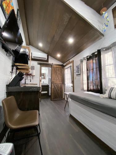 a bedroom with a bed and a desk in a room at Tiny House Leadville Colorado in Leadville