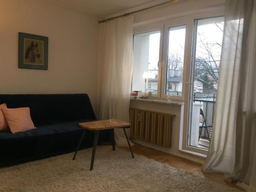 a living room with a couch and a window at Sunny Studio blisko plaży in Sopot