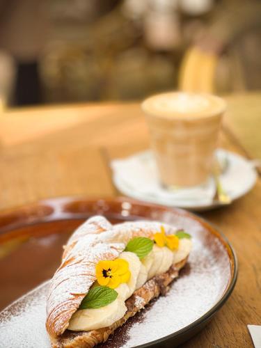 a piece of food on a plate with flowers on it at Mamma´s Boutique Hotel in Poděbrady