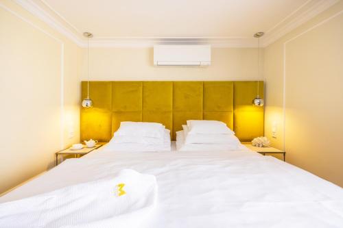 - une chambre avec 2 lits et des draps blancs dans l'établissement Mamma´s Boutique Hotel, à Poděbrady