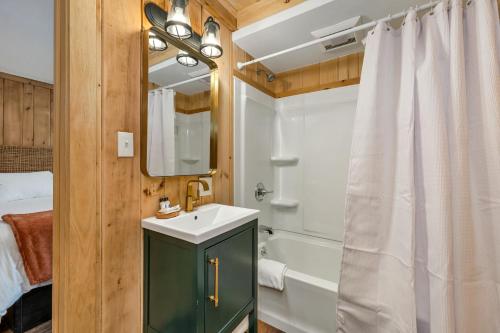a bathroom with a sink and a bath tub at The Inn & More in Bartlett