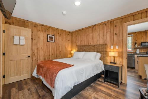 a bedroom with a bed in a wooden wall at The Inn & More in Bartlett