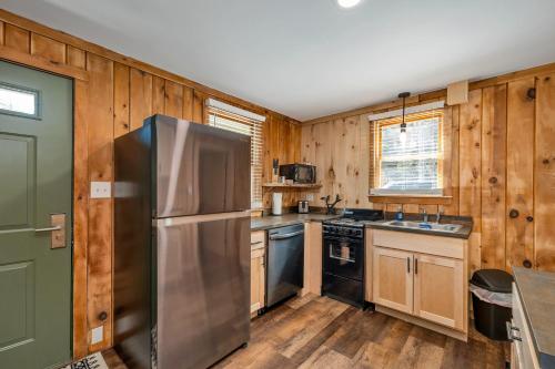 a kitchen with a stainless steel refrigerator and wooden walls at The Inn & More in Bartlett